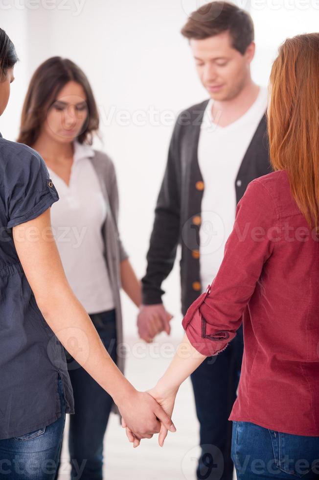 Unity and support. Group of people standing in circle and holding hands together photo