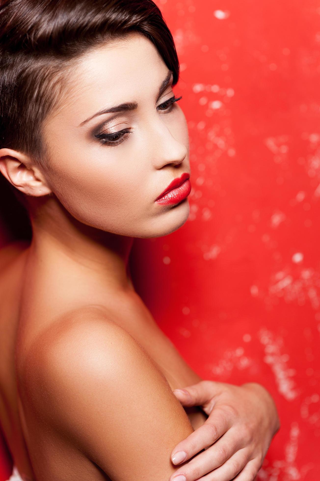 Sexy beauty. Side view of beautiful young shirtless woman standing against  red background and covering breasts with hands 13572169 Stock Photo at  Vecteezy