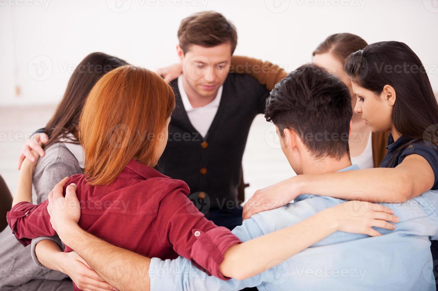 Circle of trust. Group of people sitting in circle and supporting each other photo