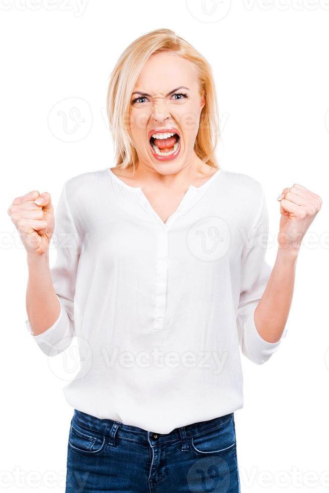 Furious beauty. Angry mature woman keeping eyes closed and covering ears with hands while standing against white background photo