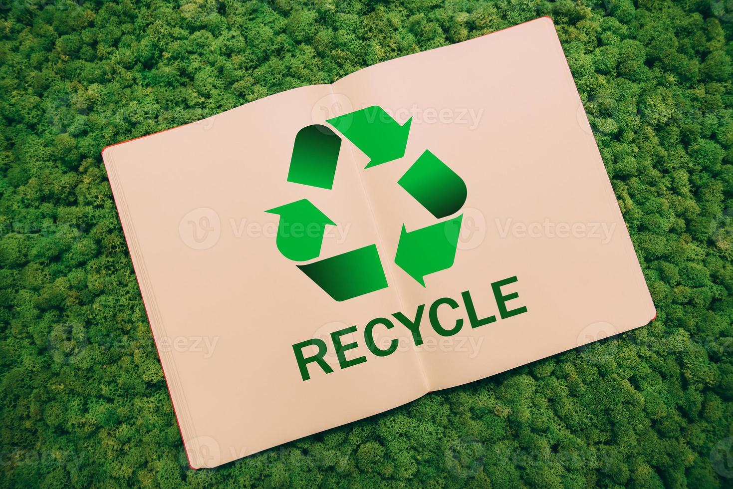 Save the planet. Top view close-up image of notebook with recycling symbol and text at moss background photo