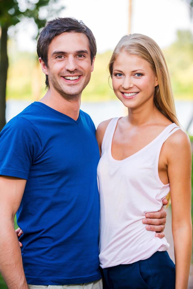 Happy loving couple. Portrait of beautiful young loving couple bonding to each other and while standing outdoors photo