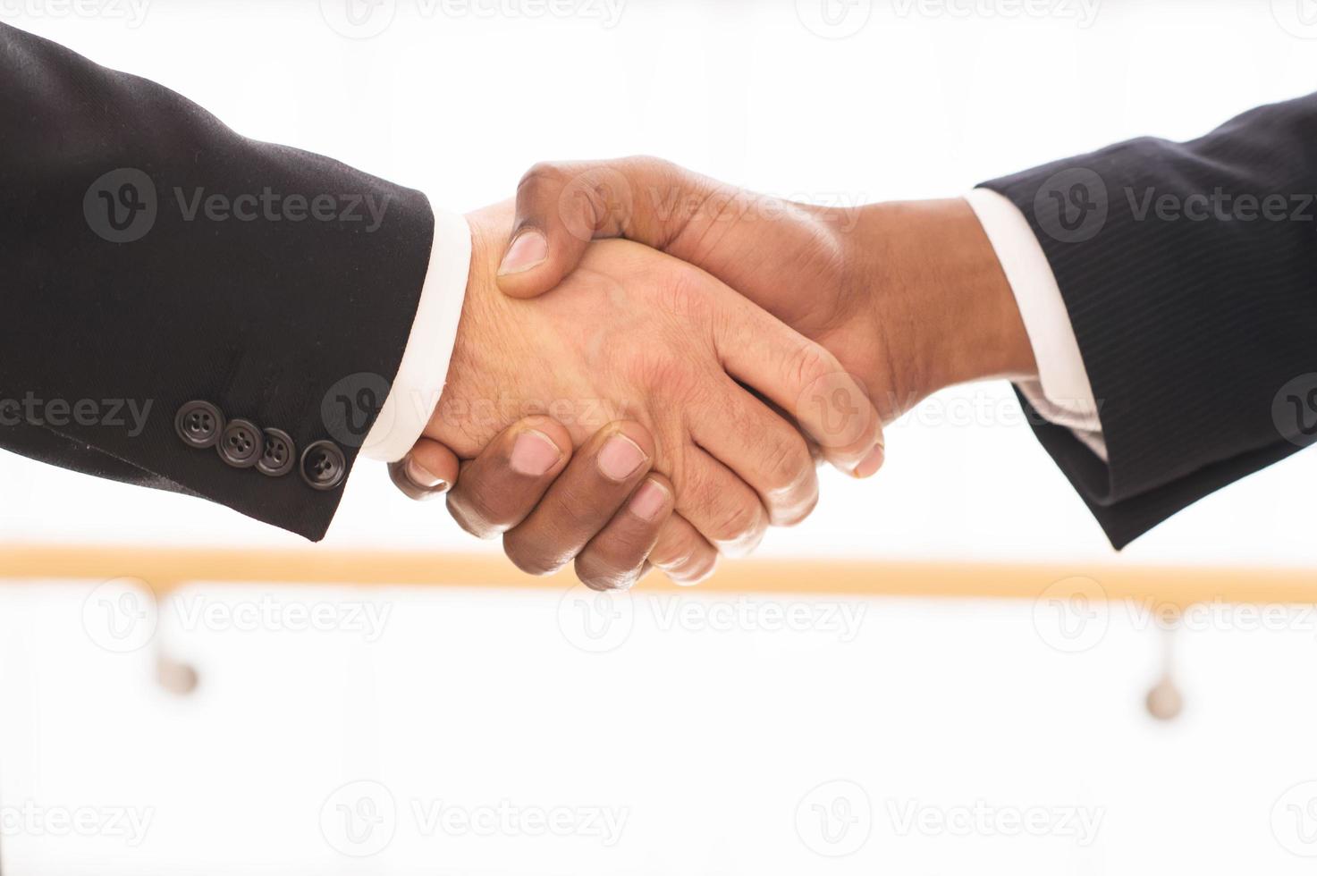 Sealing a deal. Close-up of business men shaking hands photo