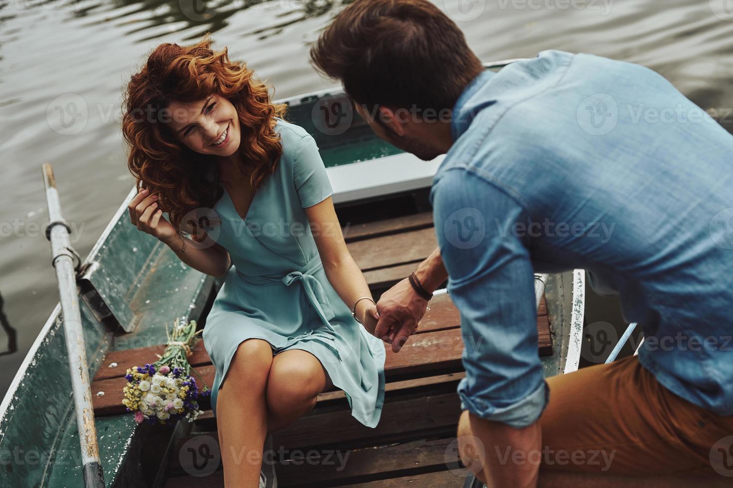Best date ever. Happy young couple getting ready to row a boat while enjoying their date outdoors photo