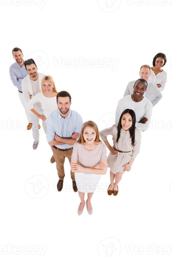 Leading her team to success. Top view of positive diverse group of people in smart casual wear looking at camera and smiling while standing close to each other photo