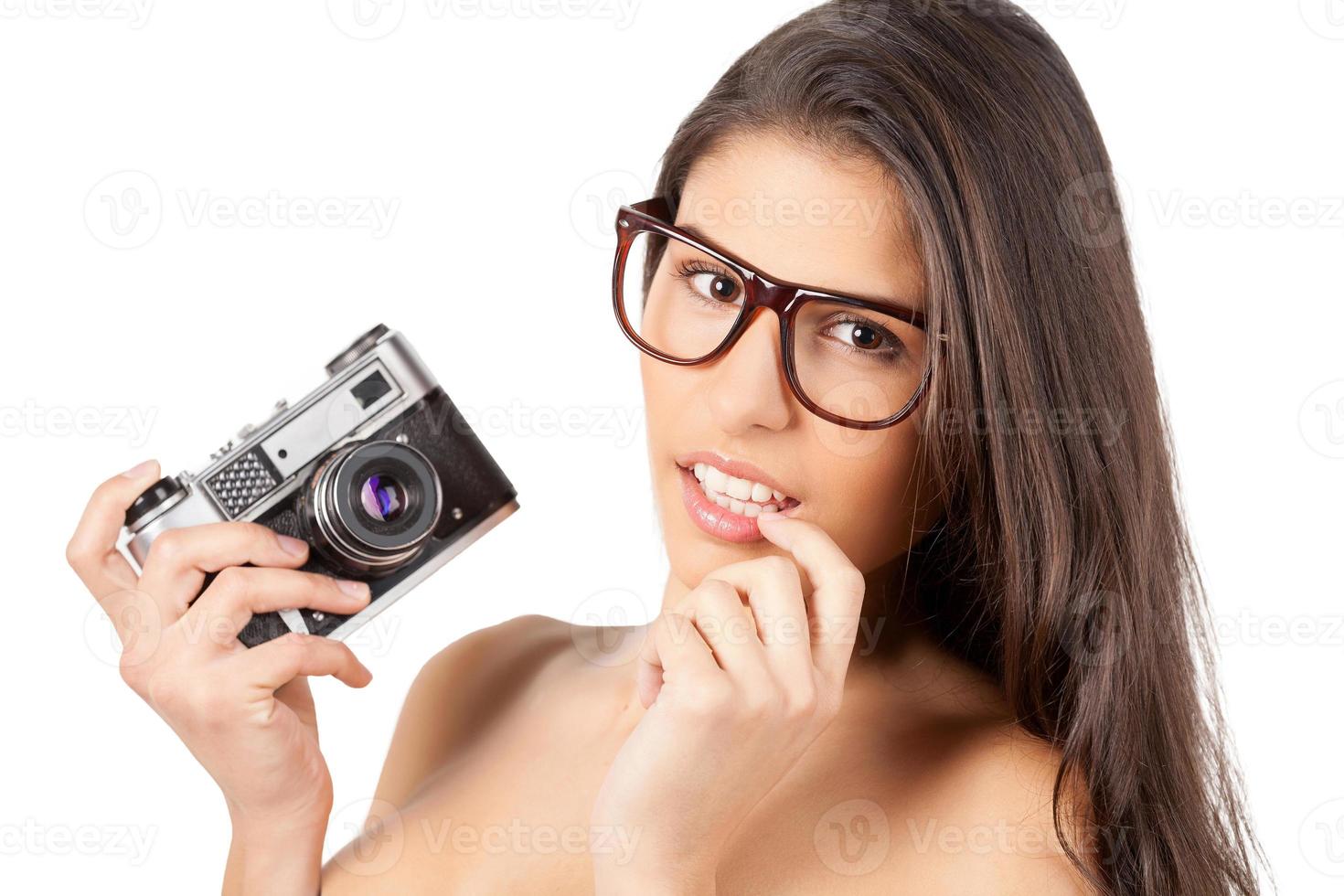 Beauty with camera. Beautiful young shirtless woman holding camera and smiling photo