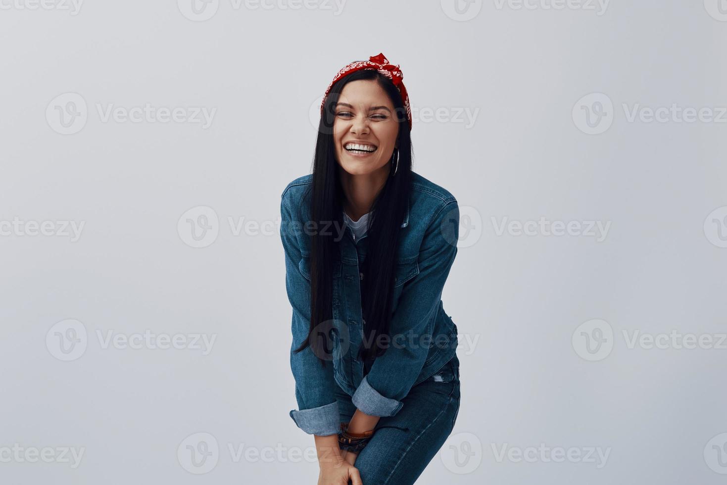 Attractive young woman in bandana looking at camera and smiling photo