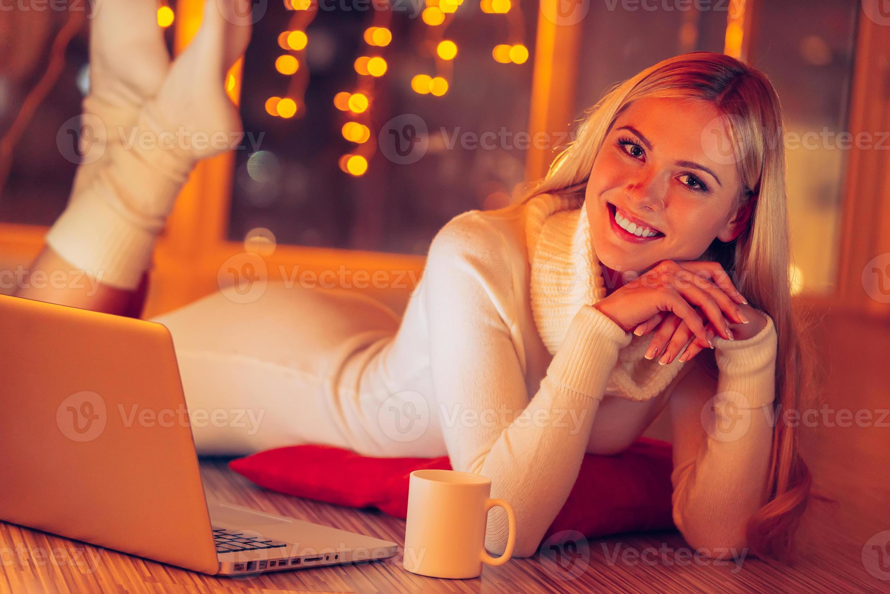 Feeling so good at home. Beautiful young woman in white sweater and