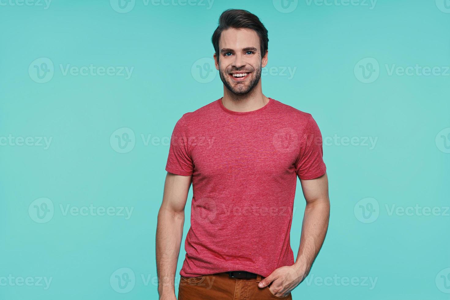 Handsome young man in casual clothing looking at camera and smiling photo