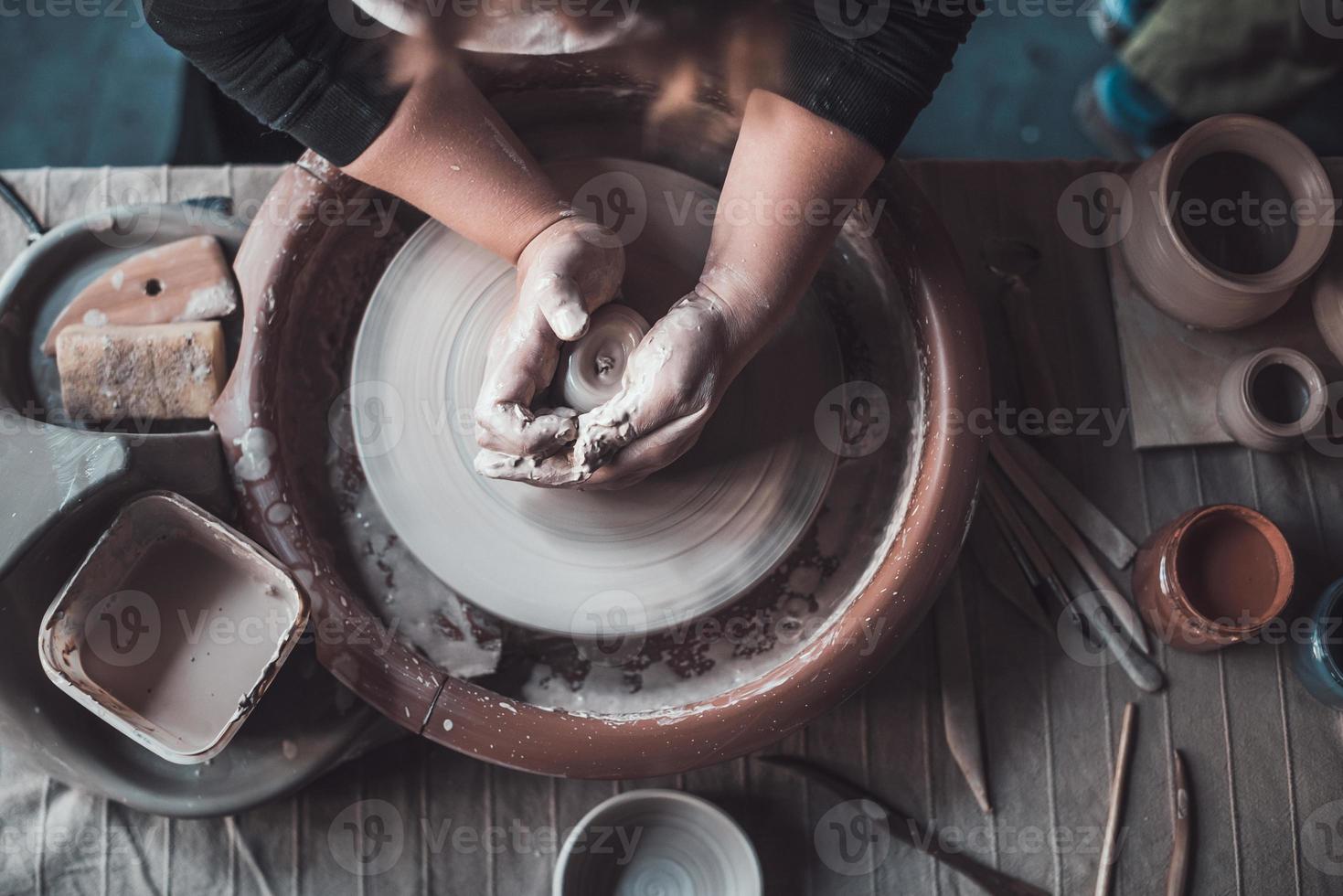 Making something special. Top view of potter making ceramic pot on the