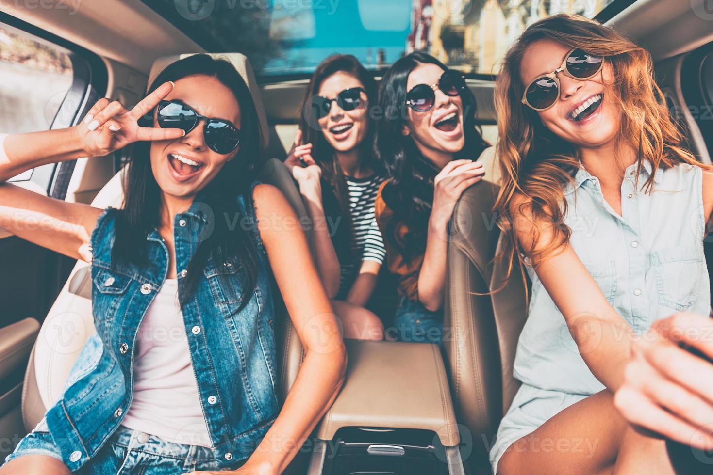 Just fun and road ahead. Four beautiful young cheerful women looking