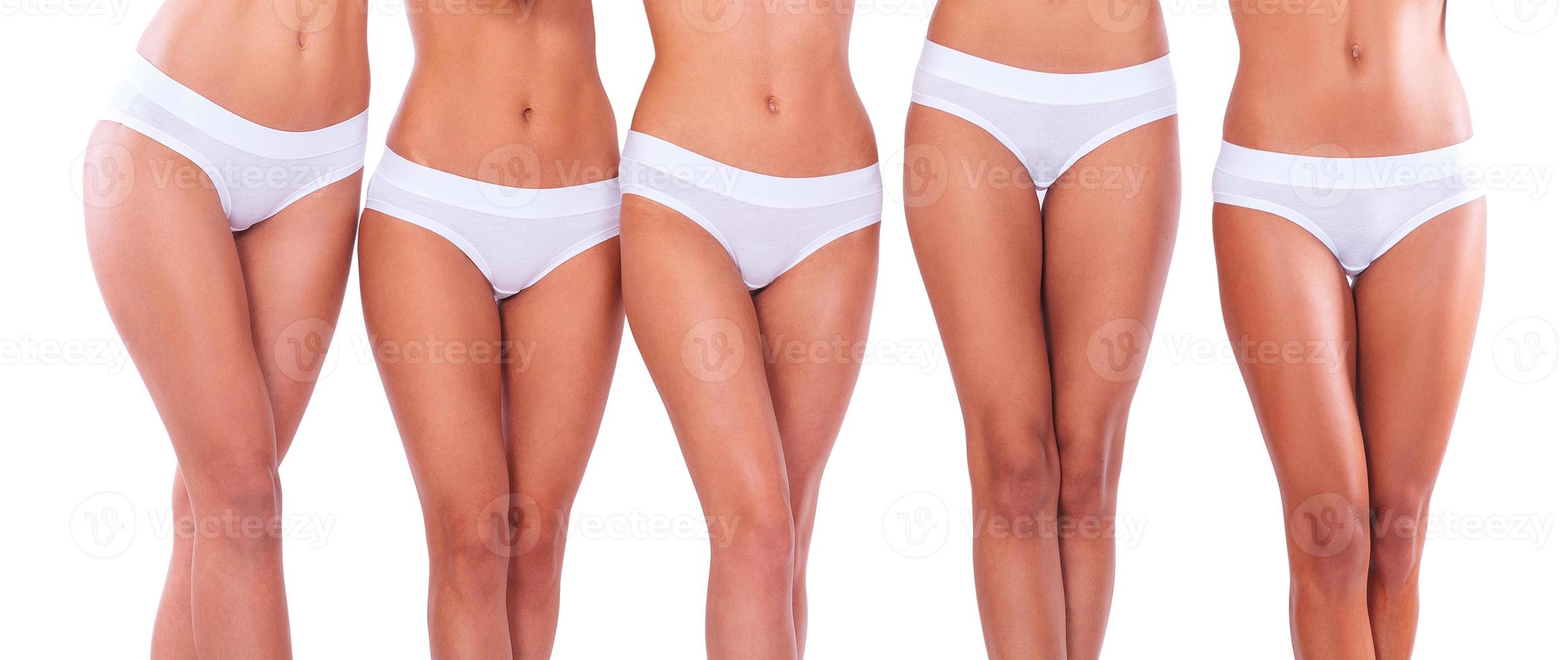 Beautiful legs. Close-up of five women in white panties standing against white background photo