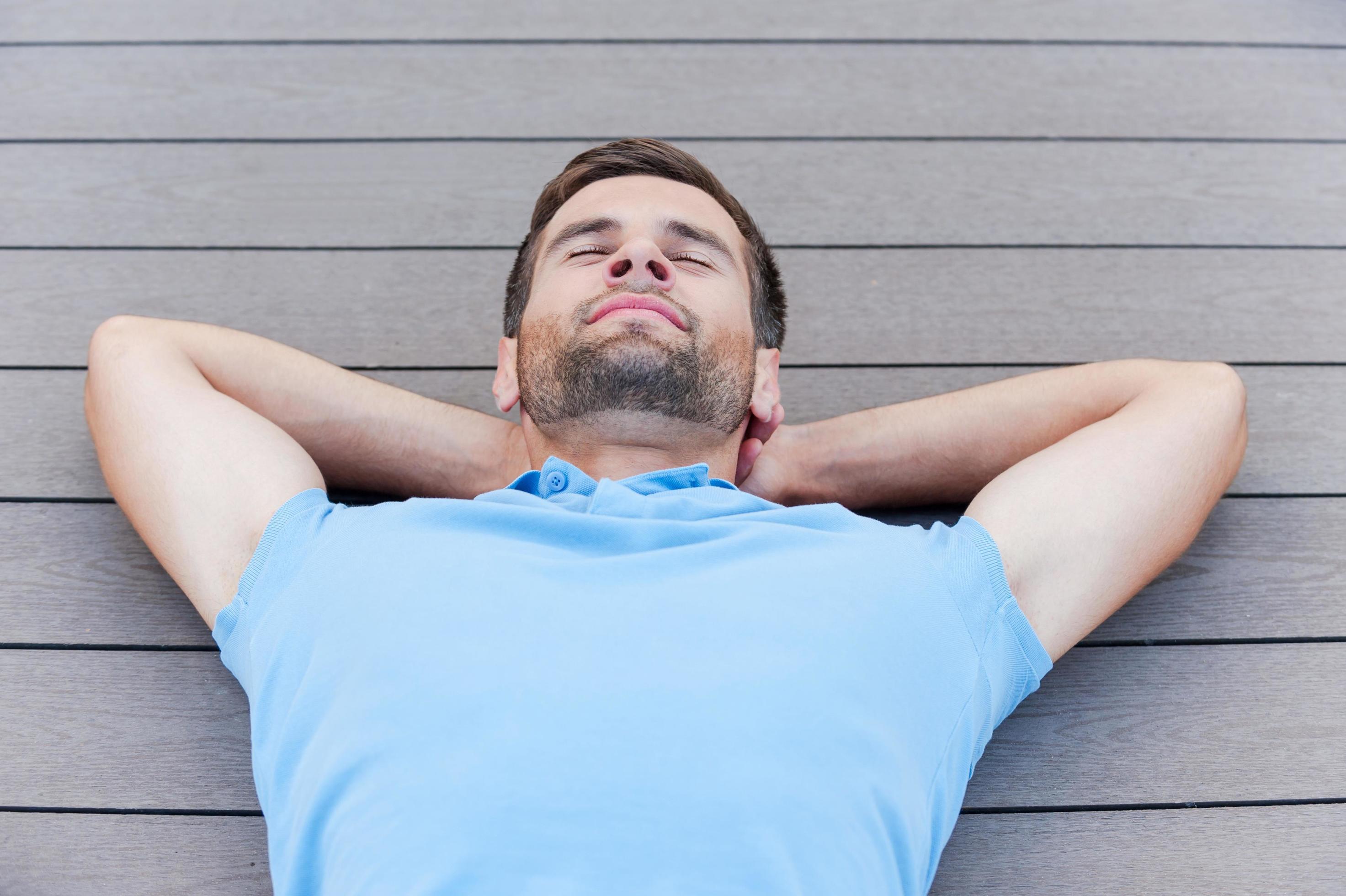 Time to relax. Top view of handsome young man keeping eyes closed