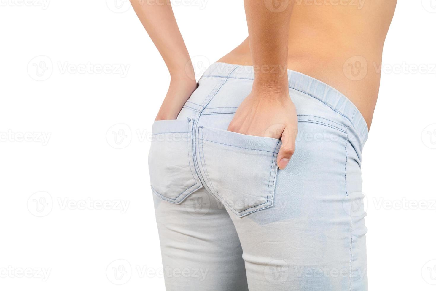 Hands in pockets. Close-up rear view of woman holding hand in jeans pockets photo