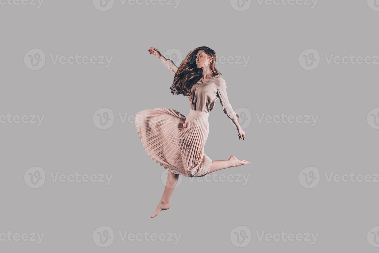 libertad en cada uno de sus movimientos. foto de estudio de una joven atractiva flotando en el aire