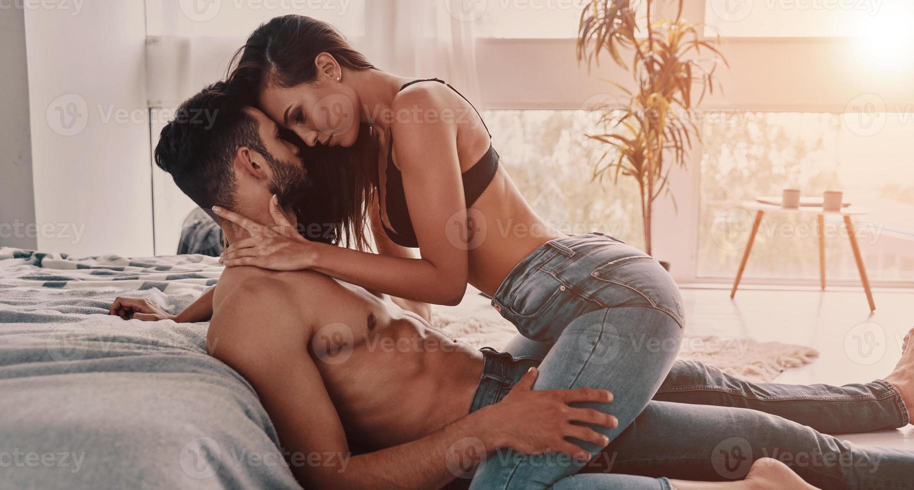 True passion. Beautiful young semi-dressed couple bonding while spending time at home photo