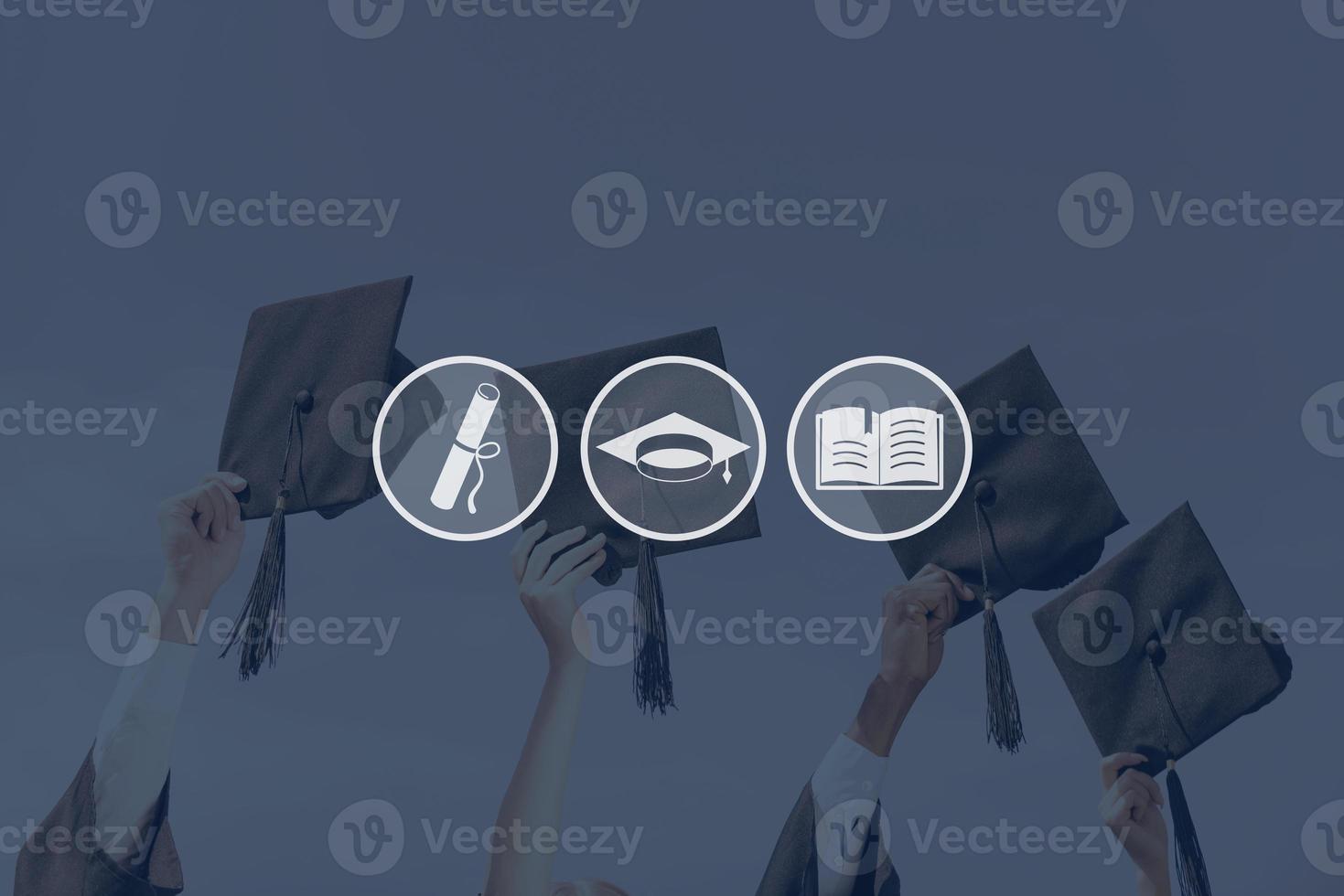 Graduation Close-up of four hands holding mortar boards against sky background photo