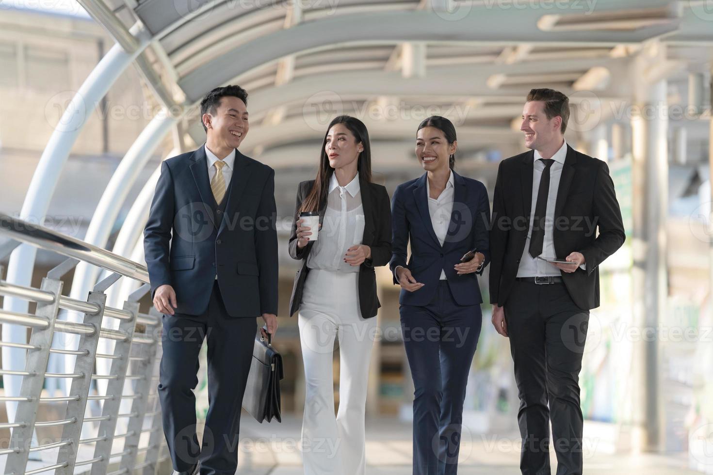 Business people walking and talk to each other in front of modern office photo