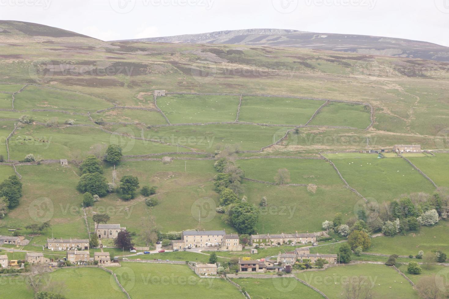 a Yorkshire Dales village with hills and fields photo