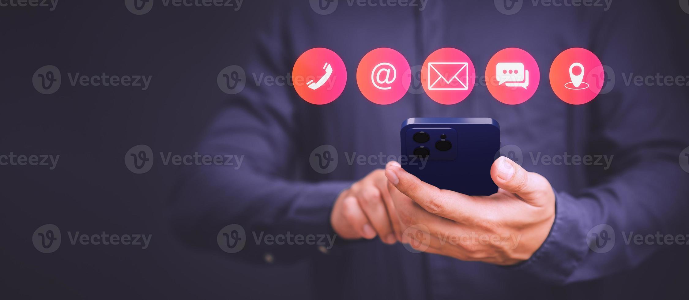 Businessman using mobile phone or smartphone with the call phone, email, address, chat message and map icons. Customer support hotline contact us people connection concept. photo