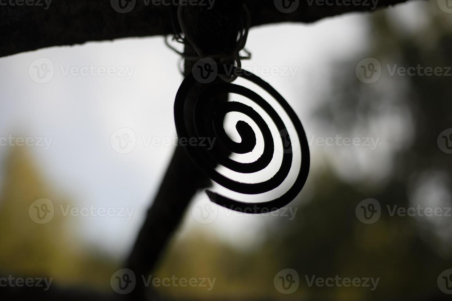 Insect spiral. Mosquito repellent. Round object on background of nature. Hiking details. photo