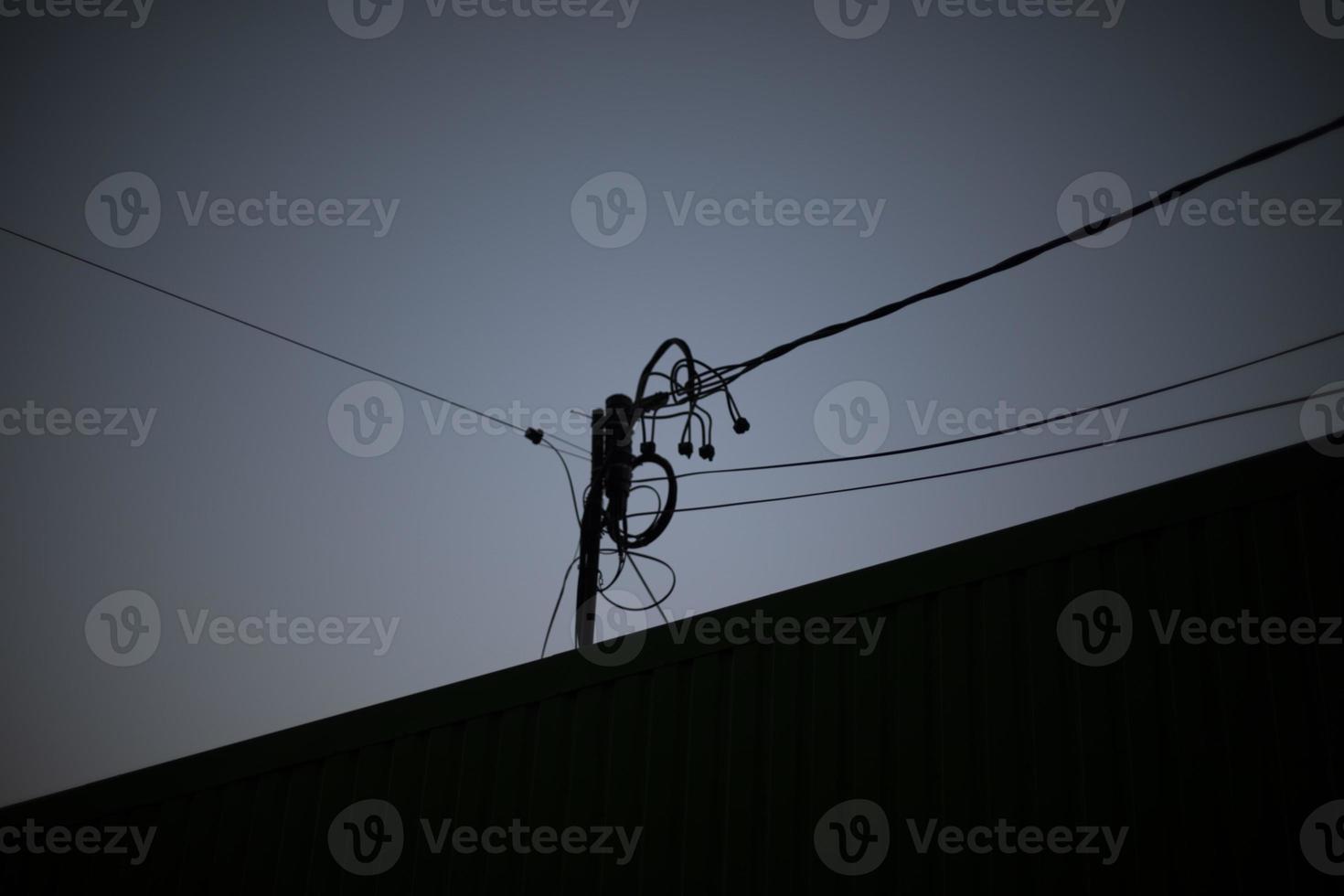 Roof wires. Silhouette of electrical wires on house. Equipment details in building. photo