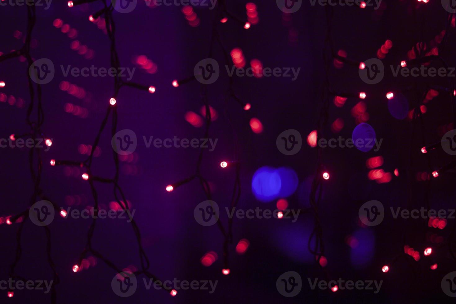 Red dots in space. Lights in dark. Red light bulbs. Lot of small lights in frame. photo