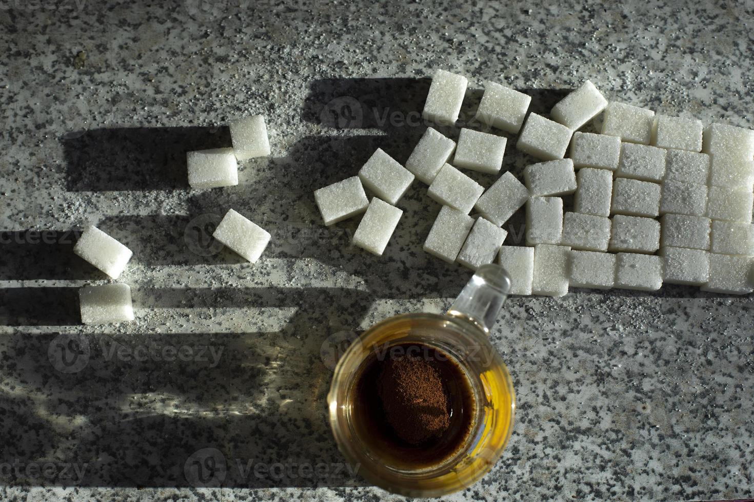 Sugar on table and tea. Lots of sugar pieces. Junk food. Breakfast details. photo