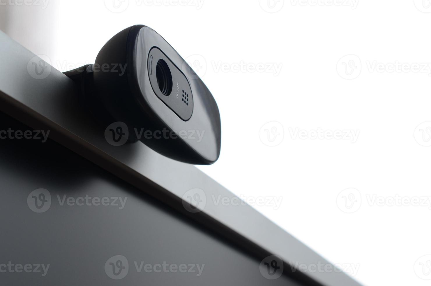 A modern web camera is installed on the body of a flat screen monitor. Device for video communication and recording of high quality video photo