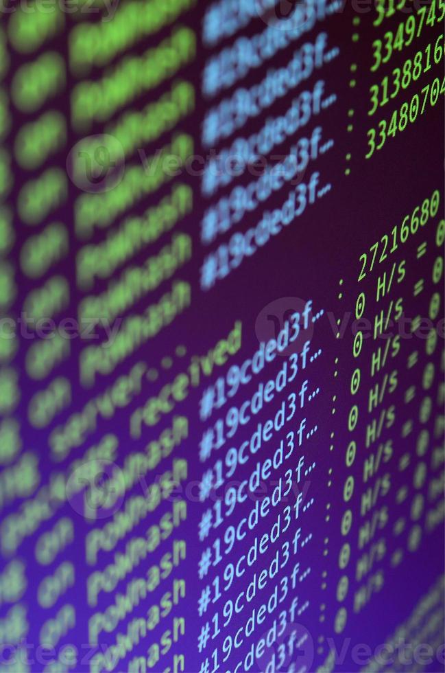 Macro snapshot of the program interface for crypto currency mining on the monitor of an office computer. The concept of mining bitcoins. The flow of information strings and data photo