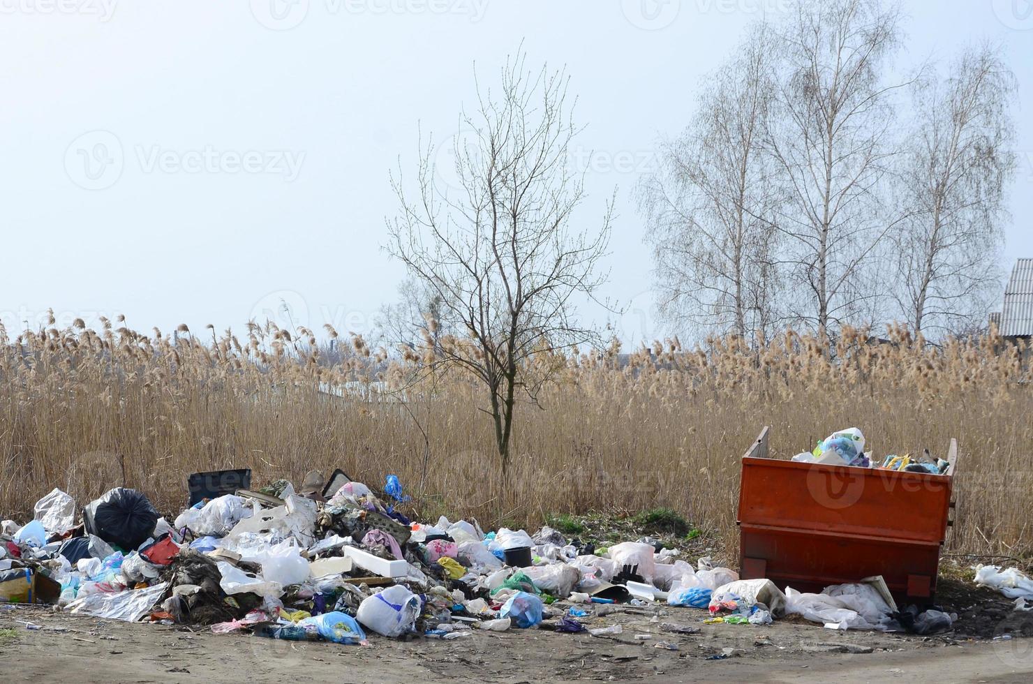 The garbage can is packed with garbage and waste. Untimely removal of garbage in populated areas photo