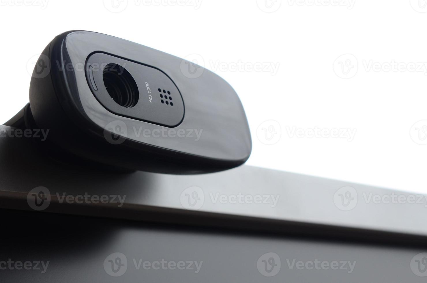 A modern web camera is installed on the body of a flat screen monitor. Device for video communication and recording of high quality video photo