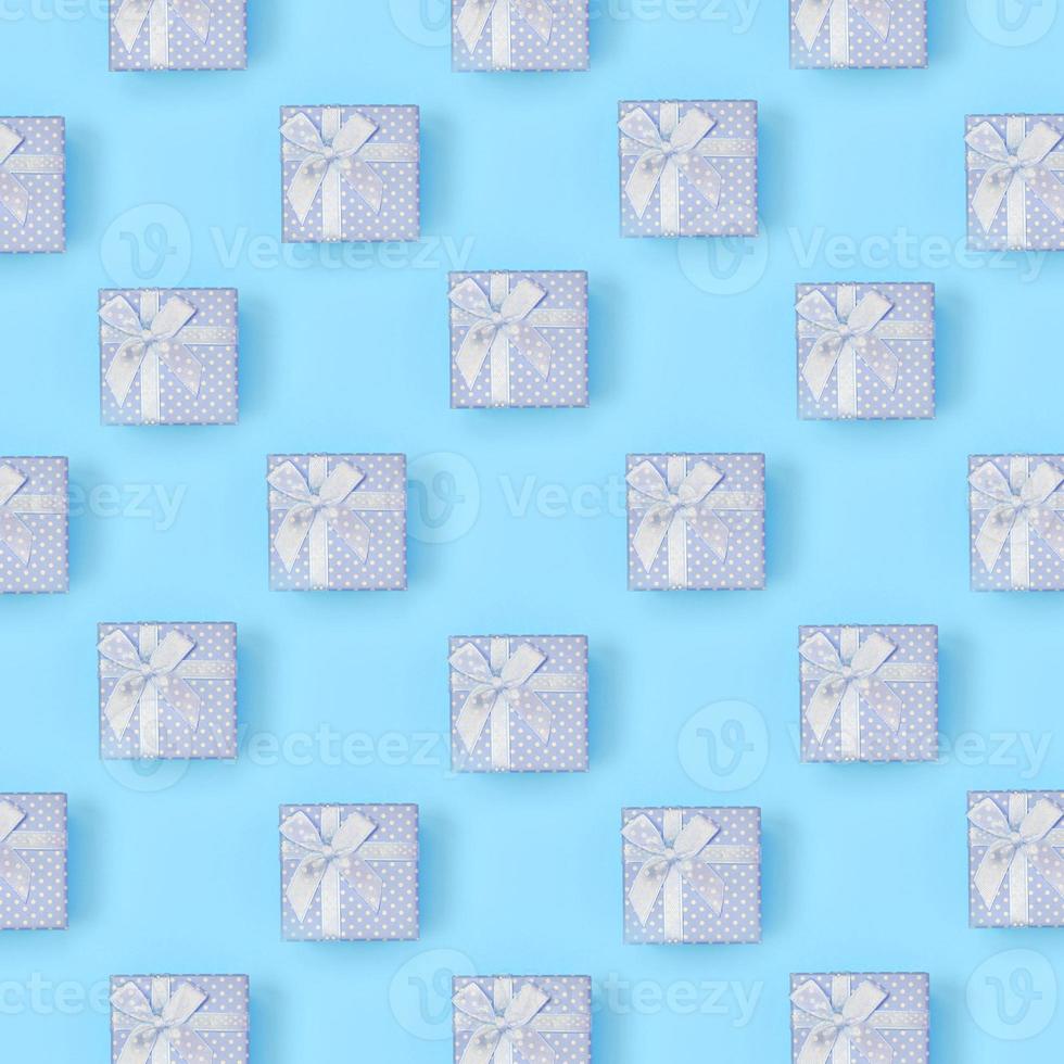 A lot of blue gift boxes lies on texture background of fashion pastel blue color paper in minimal concept photo