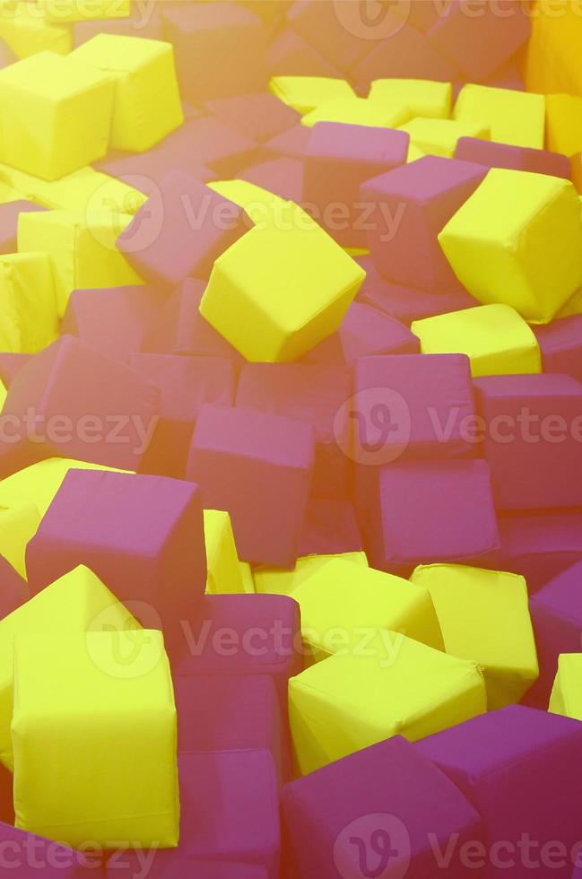 Many colorful soft blocks in a kids' ballpit at a playground photo