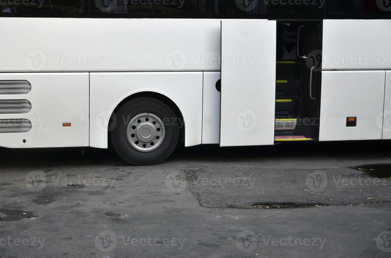 White tourist bus for excursions. The bus is parked in a parking lot near the park photo