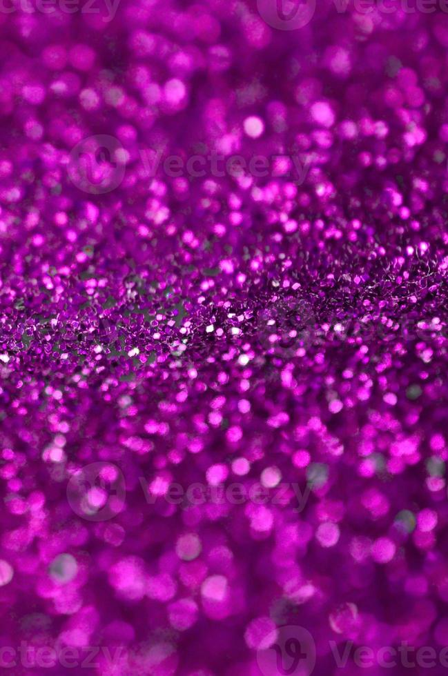 Pink decorative sequins. Background image with shiny bokeh lights from small elements photo