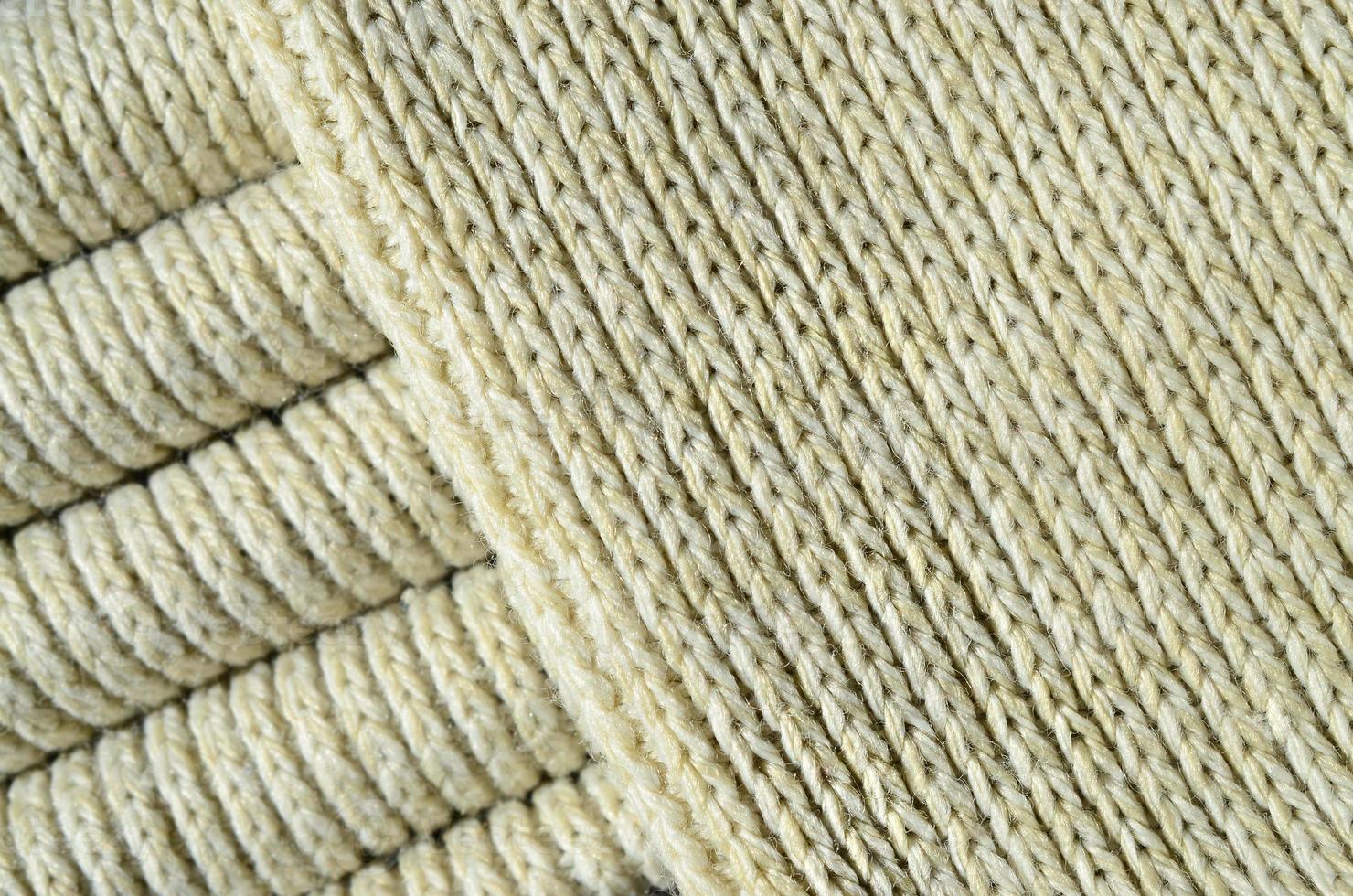 Composition of a soft yellow knitted sweater. Macro texture of bindings in yarns photo