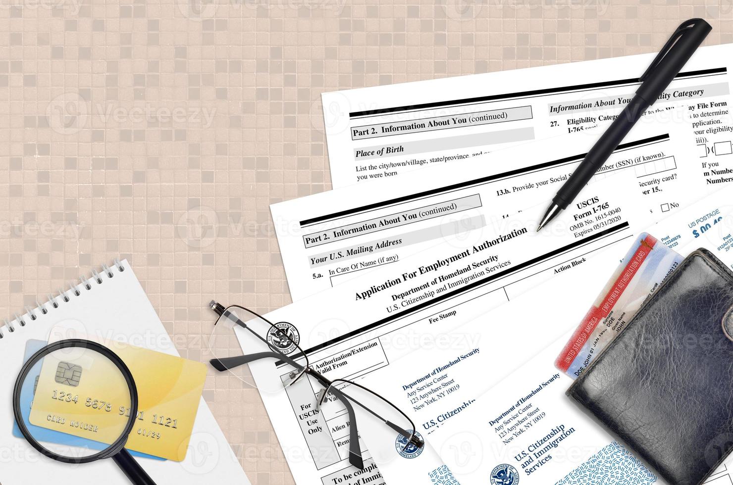 USCIS form I-765 Application for employment authorization lies on flat lay office table and ready to fill. U.S. Citizenship and Immigration services paperwork concept photo