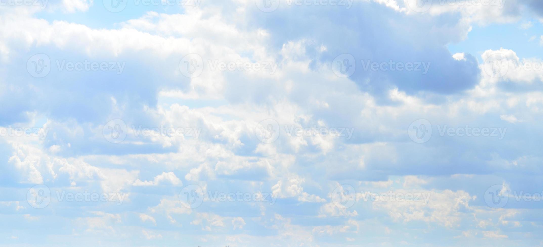 A photo of a bright and shiny blue sky with fluffy and dense white clouds