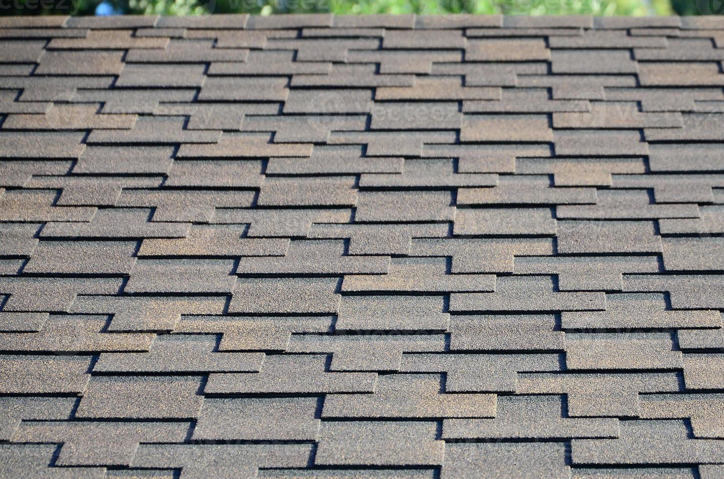 Modern roofing and decoration of chimneys. Flexible bitumen or slate shingles photo