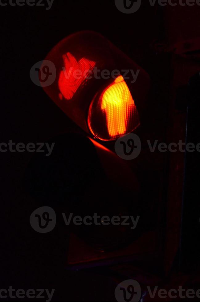 Night photo of a traffic light for pedestrians, which lights up in red