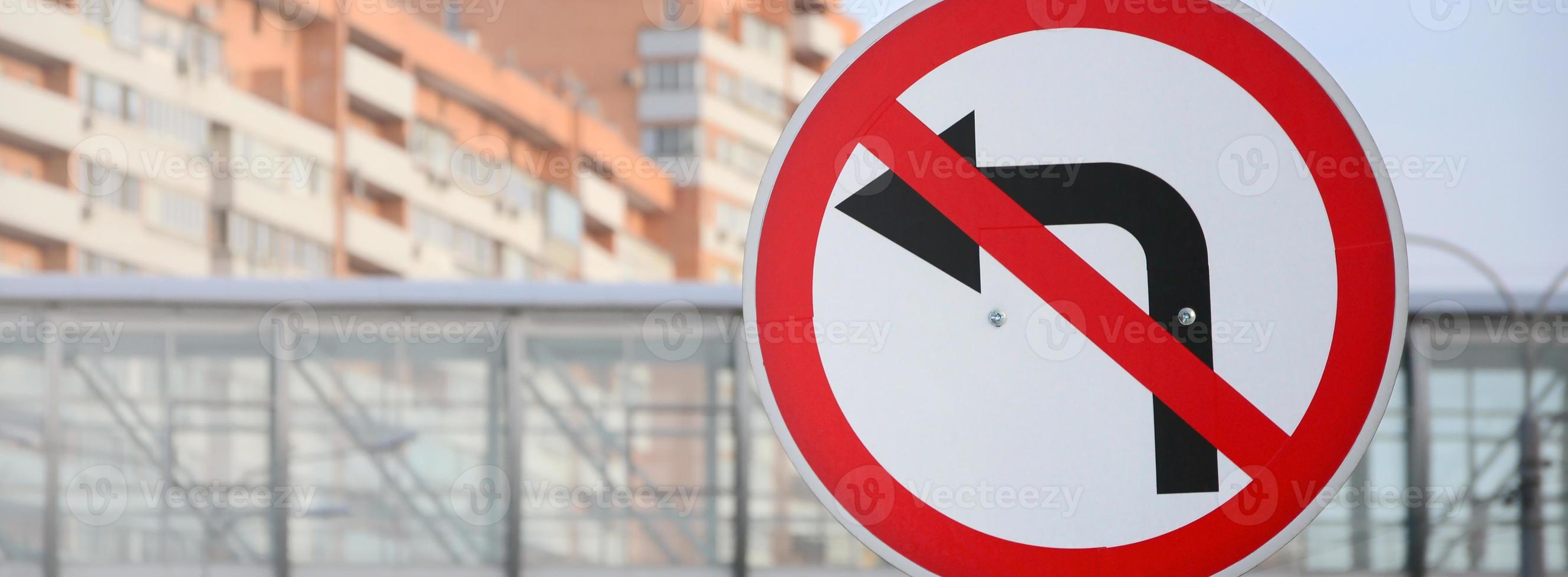 Turn left is prohibited. Traffic sign with crossed out arrow to the left photo