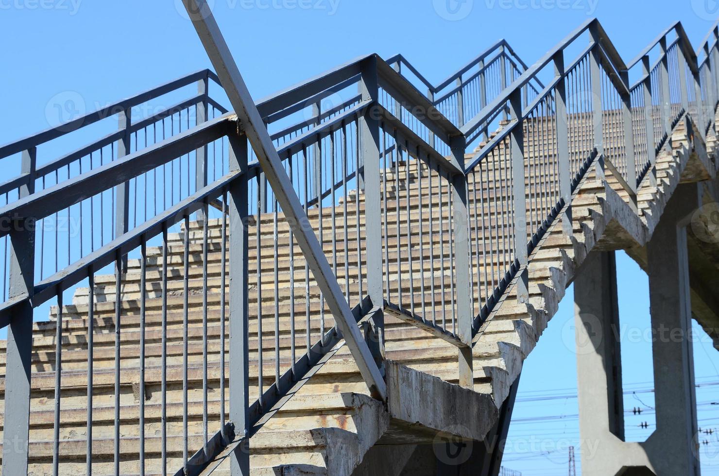 A fragment of a stepped ascent to the pedestrian bridge between the platforms of the railway station photo