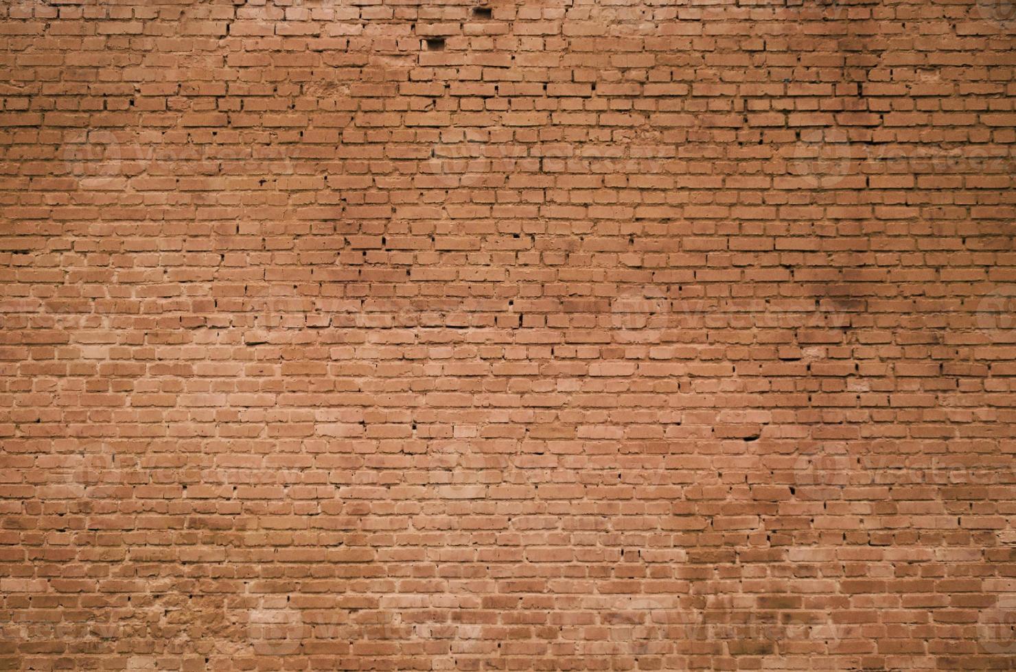 The texture of the brick wall of many rows of bricks painted in brown color photo