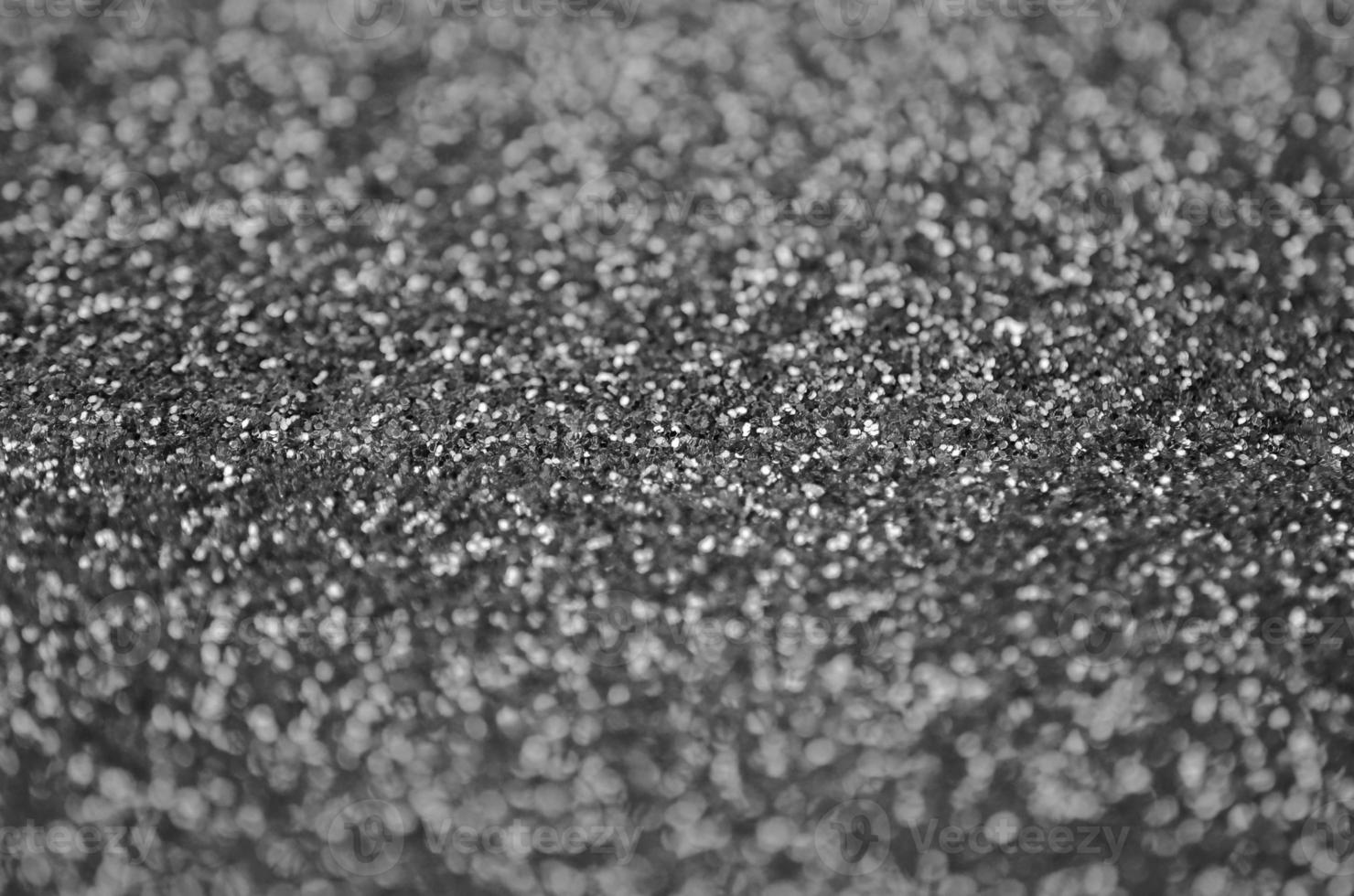 Silver decorative sequins. Background image with shiny bokeh lights from small elements photo