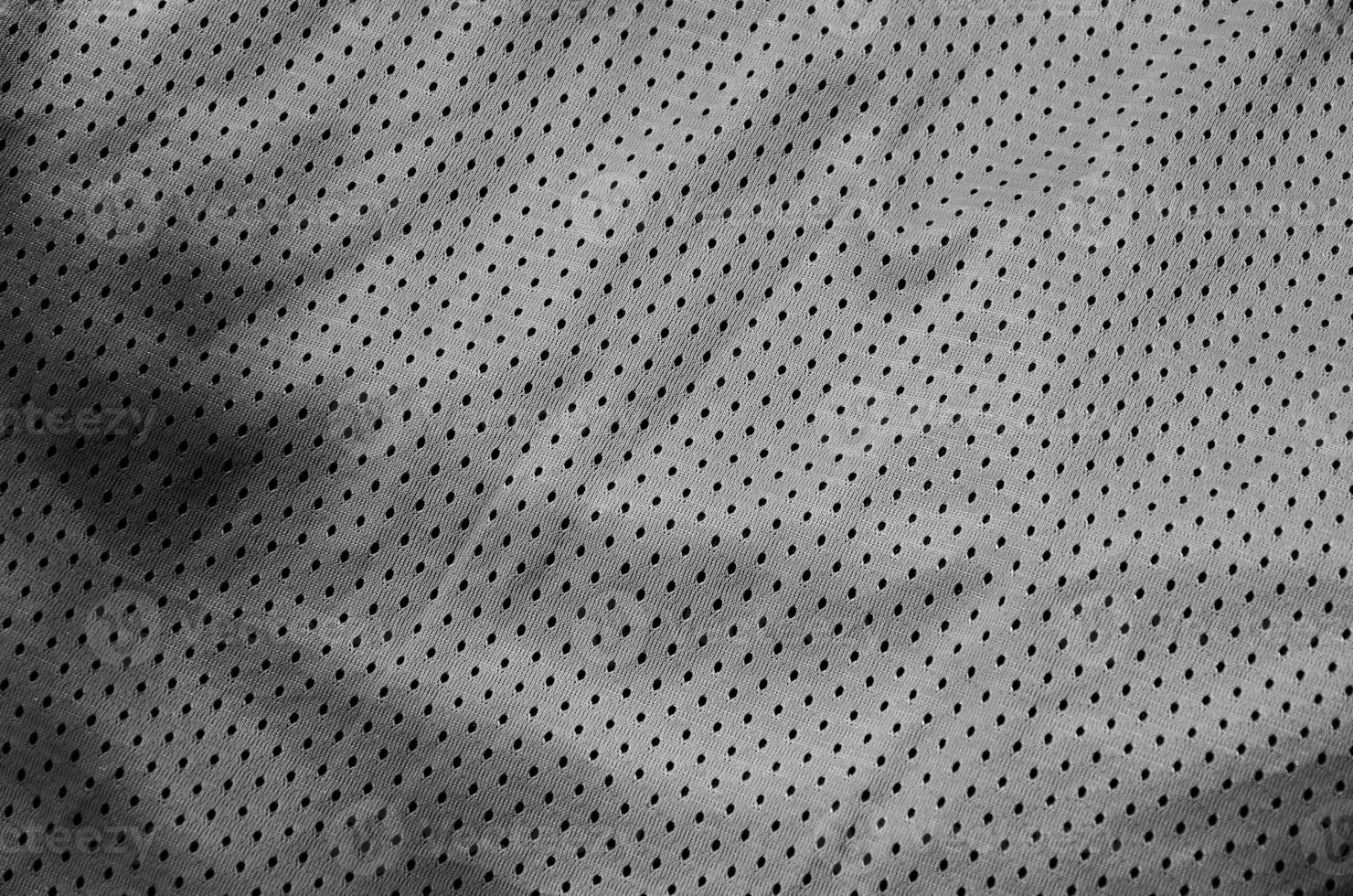 Sport clothing fabric texture background. Top view of grey polyester nylon cloth textile surface. Dark photo