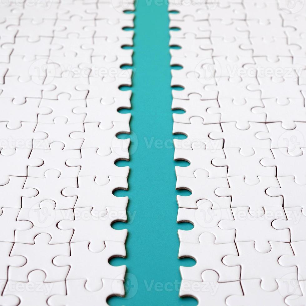 The blue path is laid on the platform of a white folded jigsaw puzzle. Texture image with copy space for text photo