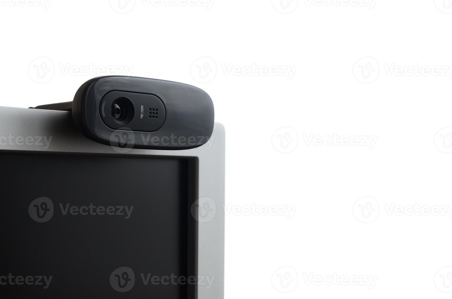 A modern web camera is installed on the body of a flat screen monitor. Device for video communication and recording of high quality video photo