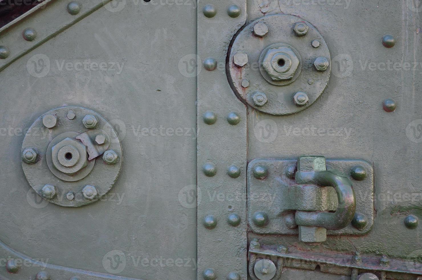 The texture of the wall of the tank, made of metal and reinforced with a multitude of bolts and rivets. Images of the covering of a combat vehicle from the Second World War photo