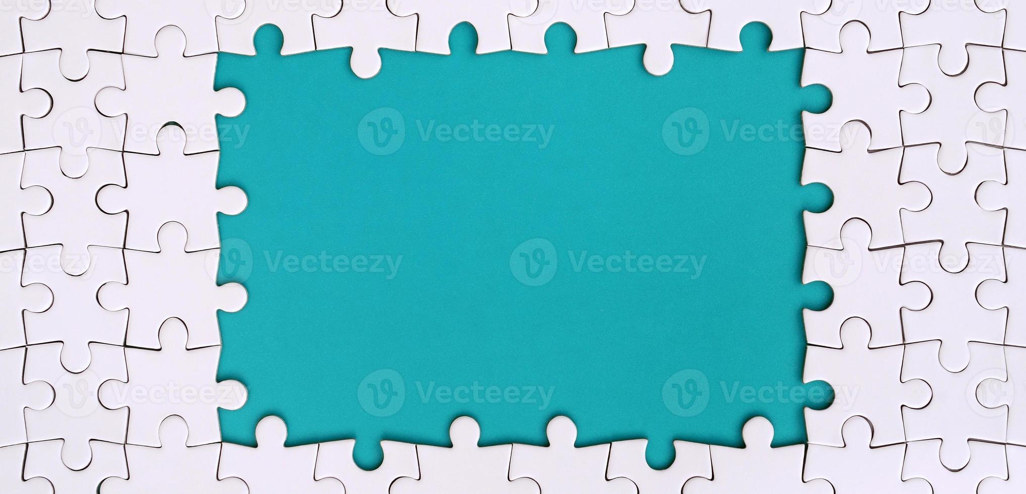Framing in the form of a rectangle, made of a white jigsaw puzzle around the blue space photo